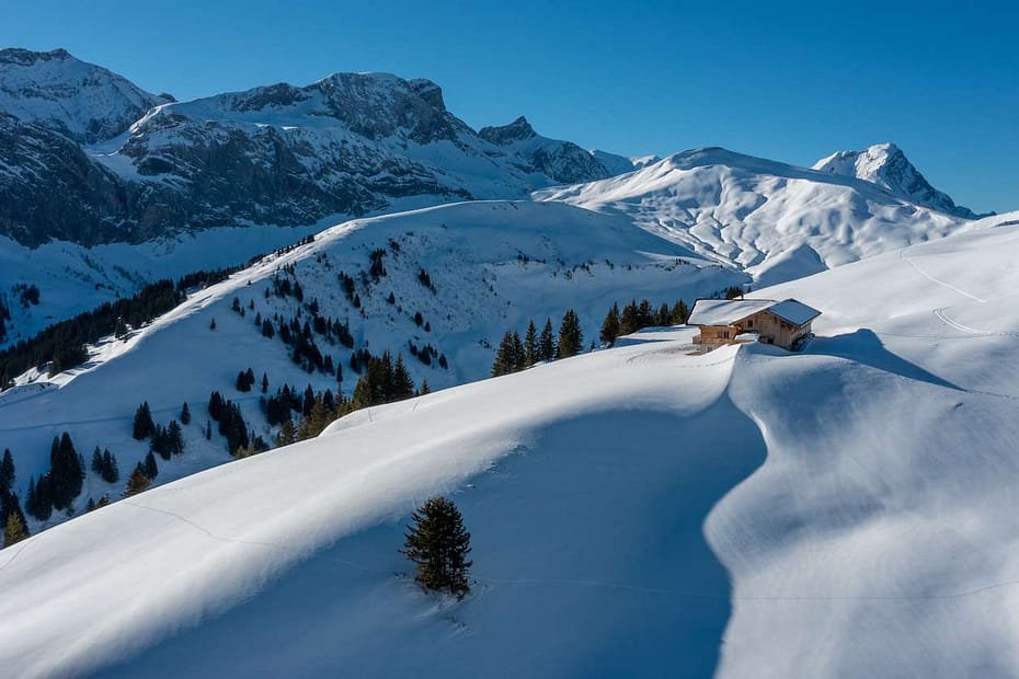 Snowy alpine landscape and cabin