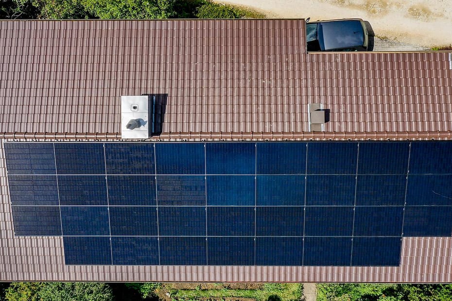 An aerial photo that shows a rooftop of a house with solar panels installed.